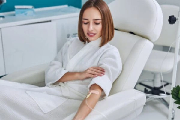 IV Nutrition patient receiving therapy sitting in a chair